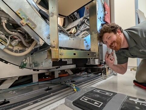 imaging technician repairing medical equipment