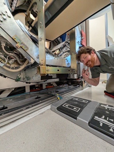 imaging technician repairing medical equipment